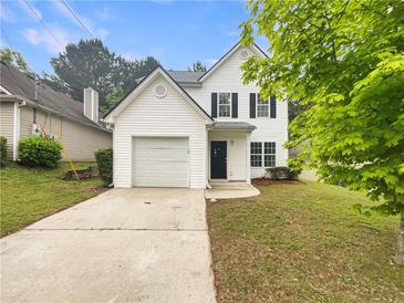 Charming two-story home with a well-maintained front yard and inviting entrance at 7007 Setters Way, Lithonia, GA 30038