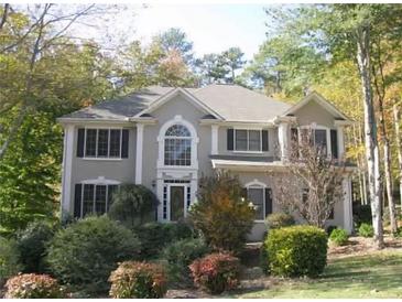 Traditional two-story home with manicured landscaping and mature trees in the front yard at 3643 Fowler Rdg, Douglasville, GA 30135