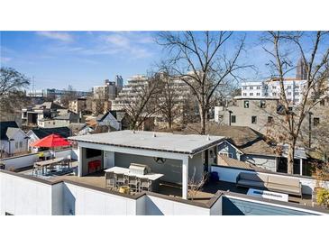 Expansive rooftop deck featuring a dining area, covered lounge, grill, and city views, perfect for entertaining guests at 522 Boulevard Ne Pl, Atlanta, GA 30308