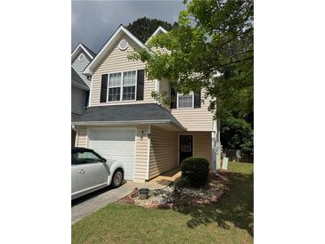 Charming two-story home featuring an attached garage, well-manicured lawn and simple landscaping at 6820 Gallant Se Cir # 2, Mableton, GA 30126