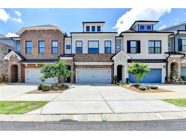 View of three townhouses showcasing individual design and a shared driveway at 240 Walker Avenue, Roswell, GA 30076