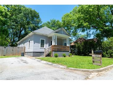 Charming single-story home featuring a cozy front porch and a well-maintained yard at 3273 Elm St, Atlanta, GA 30337