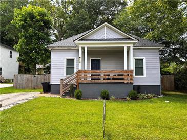 Charming home featuring a covered front porch and fresh landscaping at 3273 Elm St, Atlanta, GA 30337