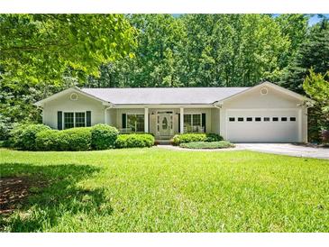 Charming one-story home with a well-maintained lawn, covered front porch, and attached two-car garage at 1294 Red Rock Rd, Acworth, GA 30101