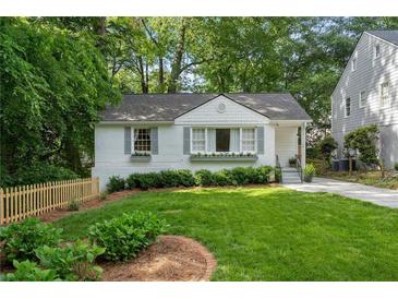 Charming white home featuring a manicured front yard, grey shutters and window boxes at 2316 Hurst Ne Dr, Atlanta, GA 30305