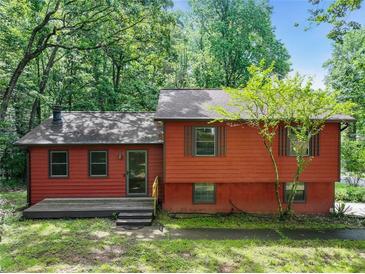 Charming split-level home with wooded surroundings and inviting front porch at 2420 Leaf Land Dr, Duluth, GA 30097