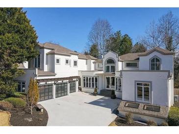 Stunning modern home with a three-car garage and beautiful architectural details at 255 Northland Ridge Trl, Atlanta, GA 30342