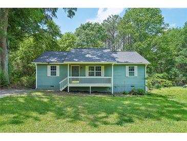 Charming, light green single-story home with a cozy front porch and well-manicured lawn at 100 Davis Mill N Rd, Dallas, GA 30157
