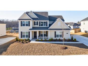 Charming two-story home with a well-manicured lawn and a welcoming front porch at 807 Parker Pass, Peachtree City, GA 30269
