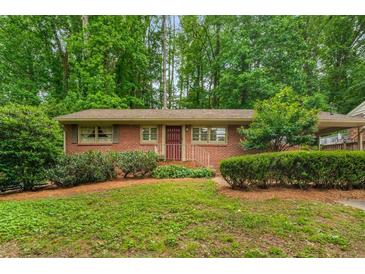 Charming brick home with a well-manicured front yard and a cozy, inviting entrance at 2559 Defoors Ferry Nw Rd, Atlanta, GA 30318