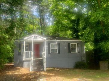 A single story home with gray siding and a small front porch at 2835 Burton Rd, Atlanta, GA 30311