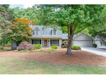 Charming two-story home with well-maintained landscaping and a welcoming front porch at 2285 Ashton Ridge Dr, Dacula, GA 30019