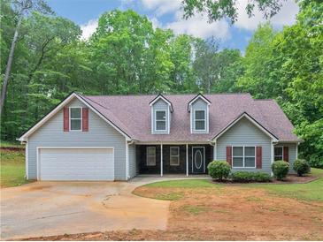 Charming single-Gathering home featuring a two-car garage, inviting front porch, and well-maintained landscaping at 445 Royal St, Mcdonough, GA 30253