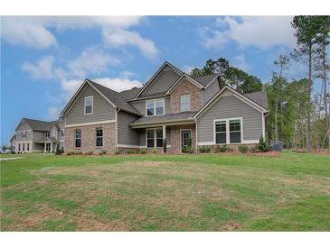 Charming two-story home with brick accents, well-manicured lawn, and inviting curb appeal on a beautiful lot at 72 Homesite Cooper W Cv, Fayetteville, GA 30215