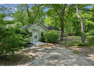 Charming home with mature trees, sidewalk and ample parking space at 4202 Maplewood Dr, Decatur, GA 30035