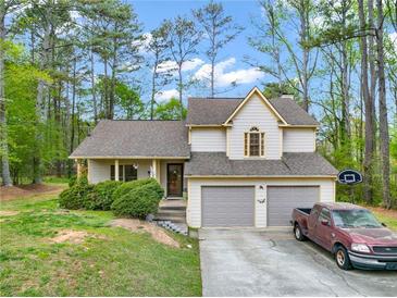 Charming home with a two-car garage, set back on a nicely wooded lot at 991 Lisa Kay Dr, Lawrenceville, GA 30046