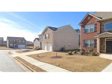 Charming homes with manicured lawns line a peaceful street at 11562 Creekstone Rd, Hampton, GA 30228