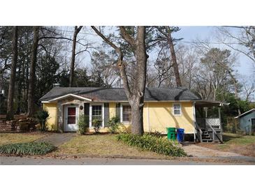 Charming single-story house with a covered porch and a cozy, welcoming facade in a wooded neighborhood at 4622 Dogwood Rd, Pine Lake, GA 30072