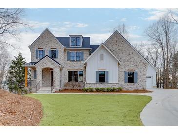 Beautiful two-story brick home with a manicured lawn and welcoming entrance at 7625 Breeze Bay Rd, Cumming, GA 30041