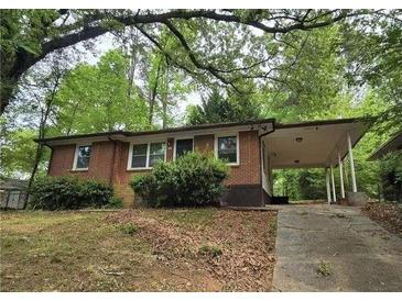 Charming single-story home with a covered carport and traditional brick facade at 767 Vinson Pl, Atlanta, GA 30315