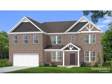 Charming two-story brick home with a landscaped yard and attached two-car garage at 2780 Dolce Rd, Dacula, GA 30019