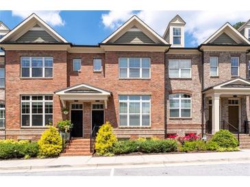 Charming brick townhouse with manicured landscaping and inviting front entrance at 1222 Lavista Ne Cir, Atlanta, GA 30324