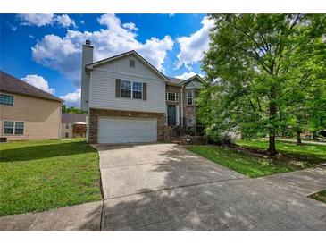 Charming two-story home with brick and siding, featuring an attached garage and well-manicured lawn and cloudy sky at 2000 Redwood Trce, Ellenwood, GA 30294