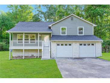 Charming two-story home with a welcoming front porch and attached two-car garage at 6625 Peppermill Ln, South Fulton, GA 30349