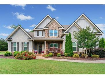 Charming two-story home with stone accents, manicured lawn, and a welcoming front porch at 161 Archstone Sq, Mcdonough, GA 30253