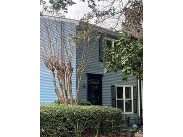 Charming blue two-story home with a black front door and window shutters surrounded by mature trees at 260 Manning Sw Rd # 42, Marietta, GA 30064