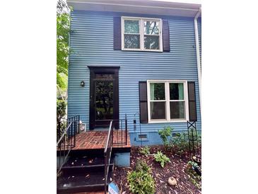 Charming home featuring a classic black front door and well-maintained brick steps at 260 Manning Sw Rd # 42, Marietta, GA 30064