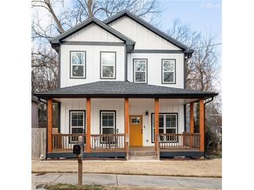 Charming two-story home with a welcoming front porch and a bright yellow door at 569 Hope Sw St, Atlanta, GA 30310