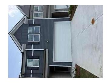 Home exterior with a light grey and dark grey siding, and a white garage door at 1122 Edinberg Dr, Villa Rica, GA 30180