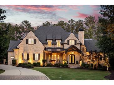 Stunning brick home with a well-manicured lawn, elegant front door, and inviting curb appeal at 670 Trinity Pl, Suwanee, GA 30024