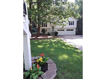 Charming two-story home with a well-manicured lawn and an inviting front entrance at 115 Jamie Dr, Hiram, GA 30141