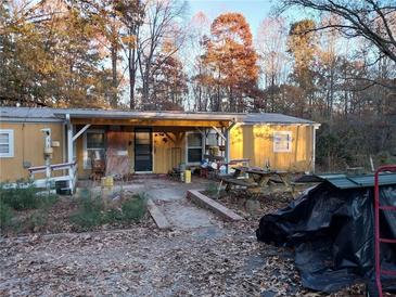 Cozy single-story home with a covered porch and mature trees at 4220 Kings Hwy, Douglasville, GA 30135