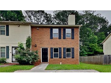 Traditional brick two-story home with dark shutters and a black front door on a small green lot at 5634 Windwood Rd, Atlanta, GA 30349