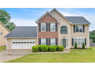 Charming two-story home with a brick facade, lush lawn and well-maintained landscaping at 2586 Abbotts Glen Nw Dr, Acworth, GA 30101