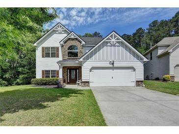 Charming two-story home with a well-manicured lawn and attached two car garage at 2020 Walking Horse Trl, Cumming, GA 30041