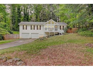 Charming two-story home features a front porch, two-car garage, and a well-maintained lawn at 3861 Hanover Ct, Marietta, GA 30062