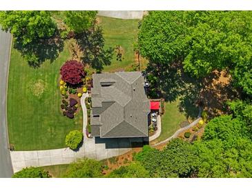 Stunning aerial view of a beautiful landscaped home with lush greenery and a cozy backyard patio at 5725 Lake Oak Lndg, Cumming, GA 30040