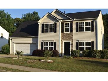Charming two-story home with a well-manicured lawn and attached two-car garage at 1371 Blazing Star Rd, Lawrenceville, GA 30045