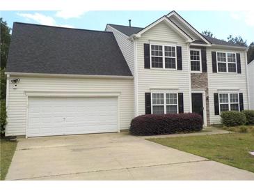 Charming two-story home with a two-car garage and well-maintained lawn and stone accents around front entry at 1371 Blazing Star Rd, Lawrenceville, GA 30045