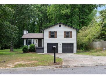 Charming home with a well-maintained lawn, two-car garage, and inviting curb appeal at 2442 Falcon Ct, Lawrenceville, GA 30043