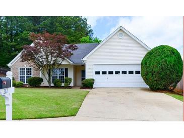 Charming home with a well-maintained lawn, mature landscaping, and a two-car garage at 282 Ellesmere Court, Buford, GA 30518