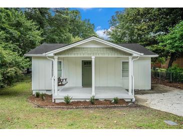 Charming cottage-style home features a cozy front porch with a swing, perfect for relaxing outdoors at 376 Pine Ne St, Marietta, GA 30060