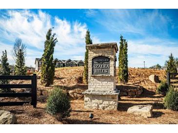 The Enclave at Azalea Hills neighborhood sign with landscaping in front of new construction homes at 235 Ivey Ter, Temple, GA 30179
