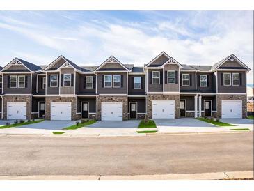 Charming townhomes with two-car garages, dark siding, brick accents, and symmetrical gable roofs at 235 Ivey Ter, Temple, GA 30179