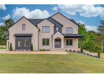 Beautiful two-story home with modern brickwork, a well-manicured lawn, and professional landscaping at 3203 Bold Springs Rd, Dacula, GA 30011