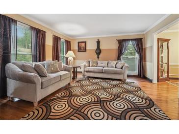 Inviting living room featuring hardwood floors, neutral paint, and comfortable sofas at 2030 Spring End Ct, Lawrenceville, GA 30044